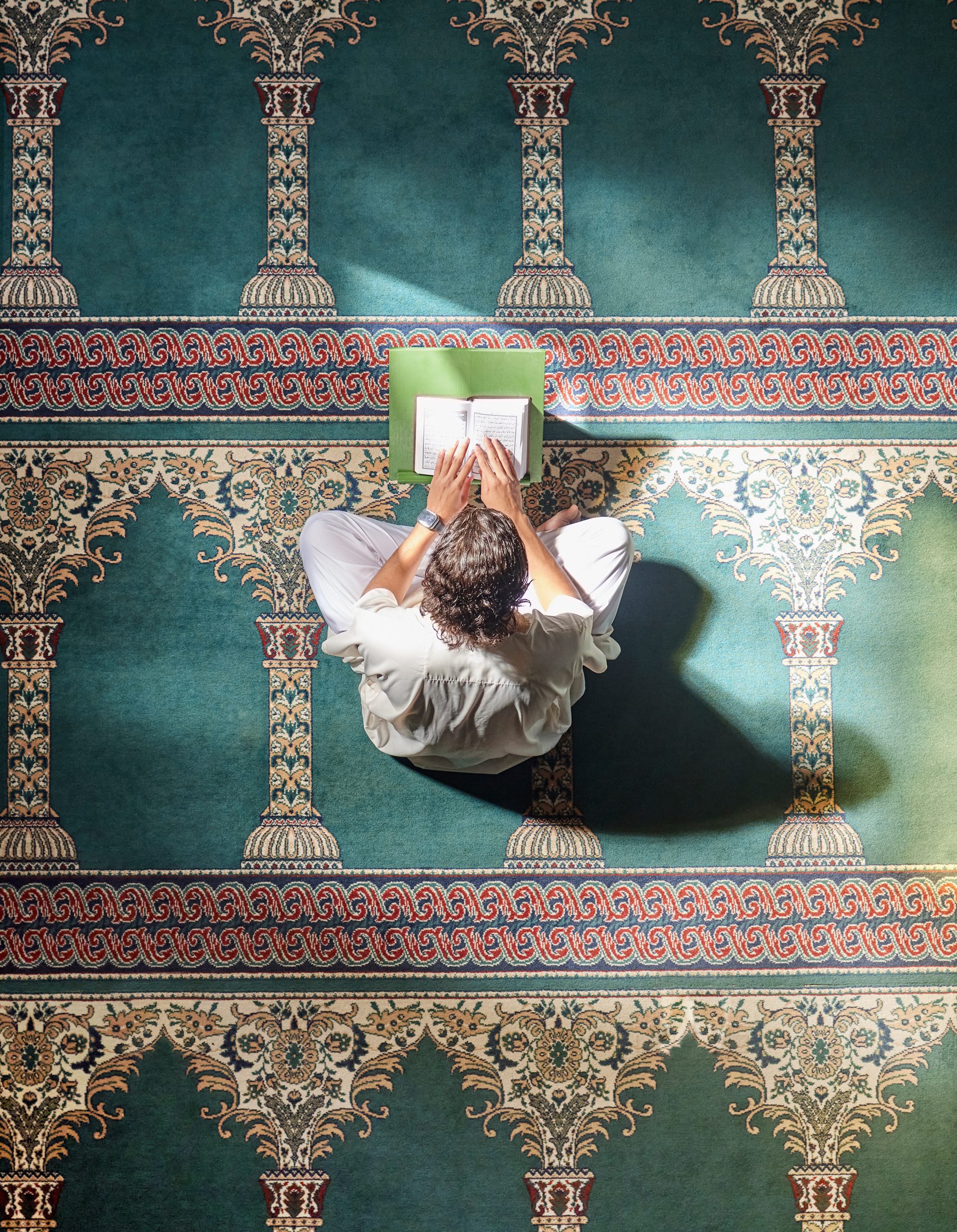 A man reading Holy Quran inside a Mosque